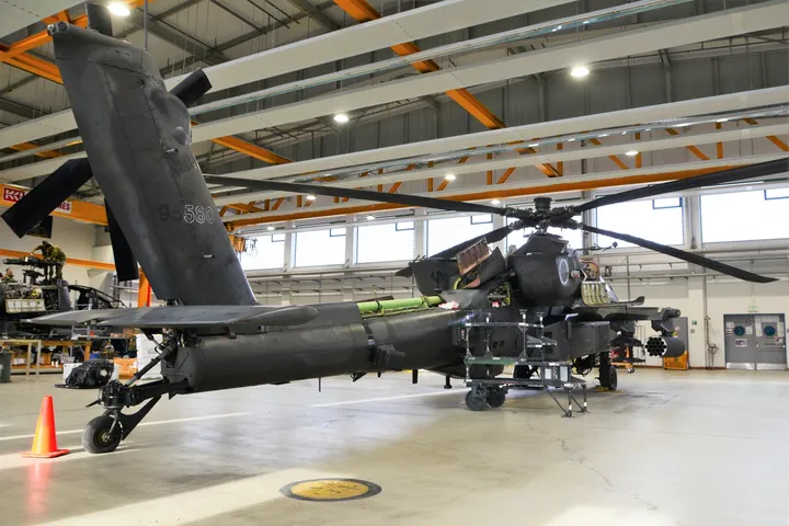 Aviation engineer performing detailed helicopter maintenance inspection